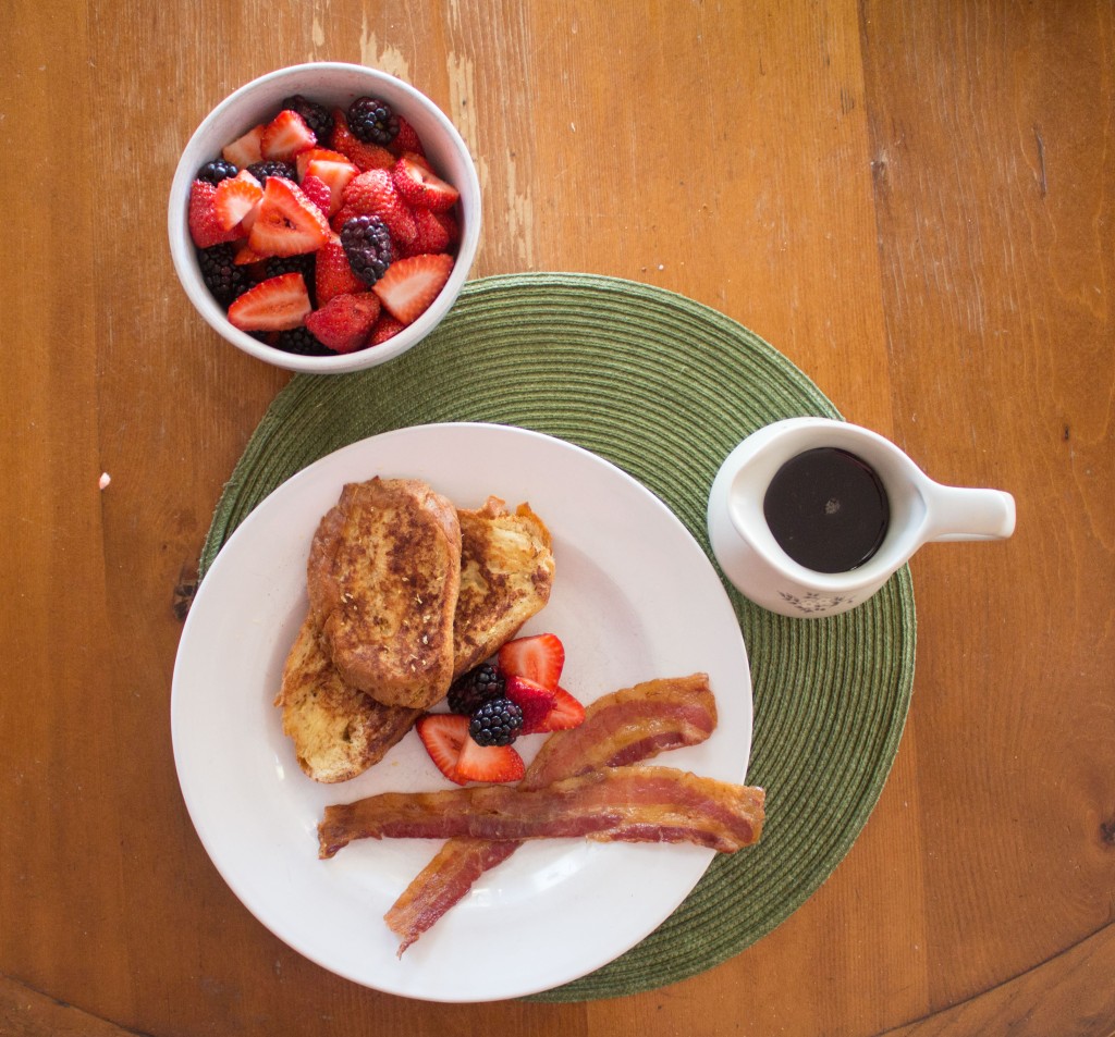 French toast, bacon, berries, and syrup.